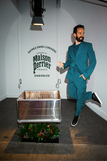 Man posing in front of Maison Perrier display